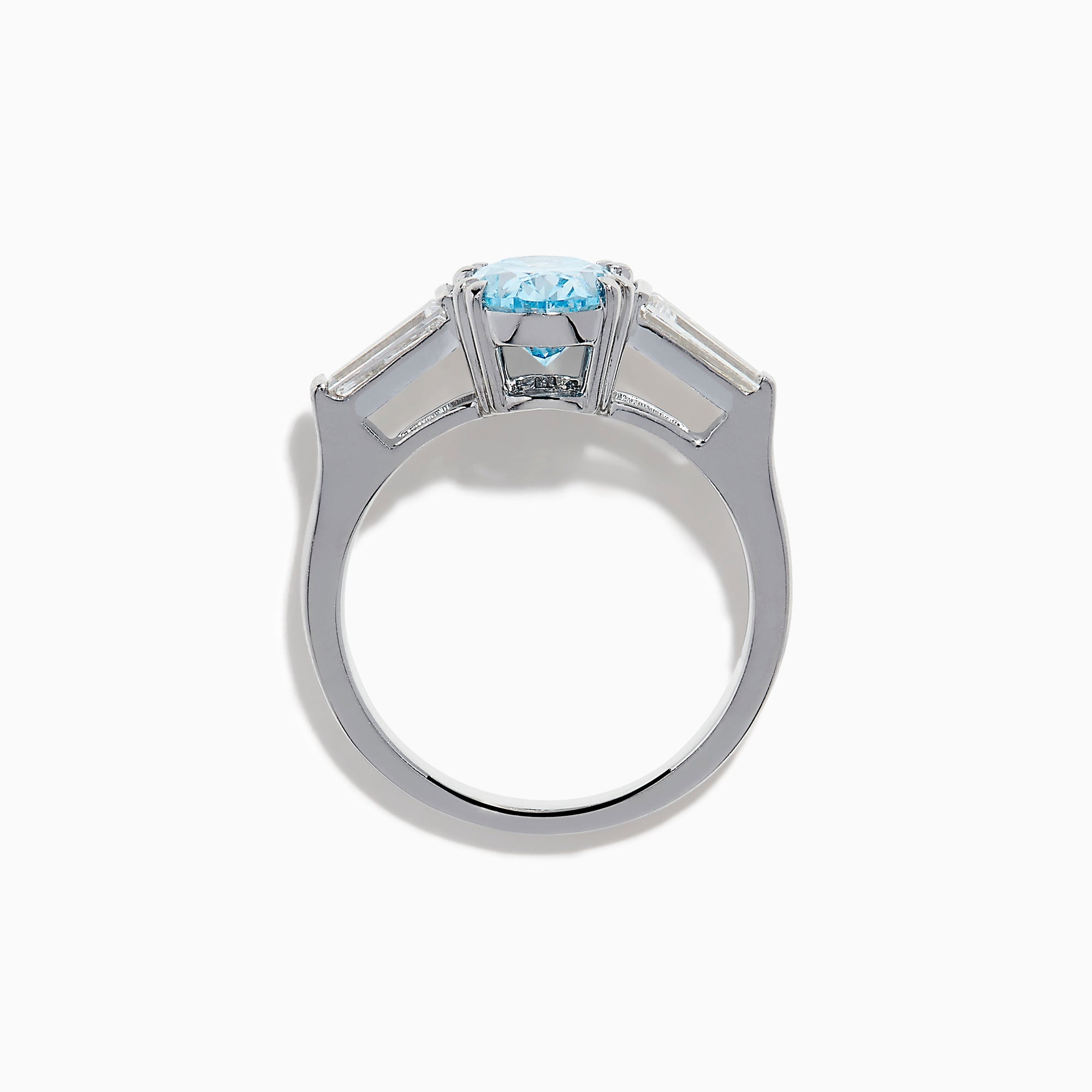 The Lab Grown Blue and White Diamond 3-Stone Ring in 14K White Gold showcases an oval blue diamond flanked by tapered white baguette diamonds, all set against a plain white background.