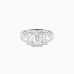 The Lab Grown Emerald Cut Diamond 3 Stone Ring in 14K White Gold features a central emerald-cut lab-grown diamond flanked by two rectangular diamonds on each side.