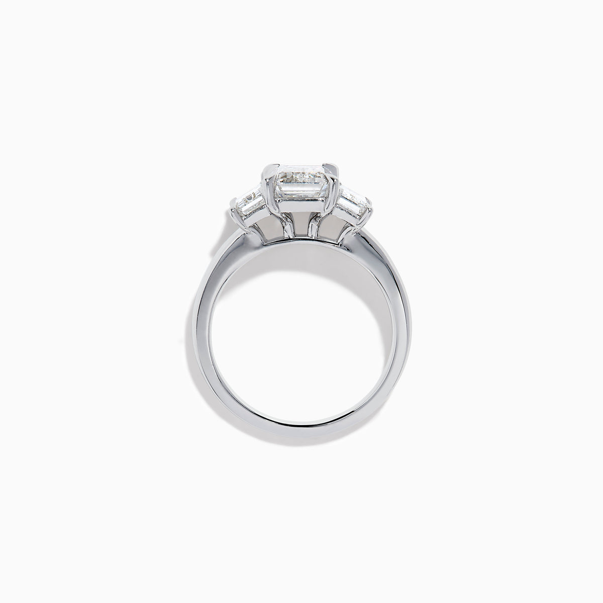 The Lab Grown Emerald Cut Diamond 3 Stone Ring in 14K White Gold features a central emerald-cut lab-grown diamond flanked by two rectangular diamonds on each side.
