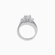 The Lab Grown Emerald Cut Diamond 3 Stone Ring in 14K White Gold features a central emerald-cut lab-grown diamond flanked by two rectangular diamonds on each side.