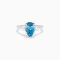 The Lab Grown Blue and White Diamond 3-Stone Ring in 14K White Gold features a large pear-shaped blue gemstone center with two rectangular lab grown diamonds, all set in white gold and displayed on a white background.