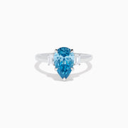 The Lab Grown Blue and White Diamond 3-Stone Ring in 14K White Gold features a large pear-shaped blue gemstone center with two rectangular lab grown diamonds, all set in white gold and displayed on a white background.