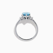 The Lab Grown Blue and White Diamond 3-Stone Ring in 14K White Gold features a large pear-shaped blue gemstone center with two rectangular lab grown diamonds, all set in white gold and displayed on a white background.