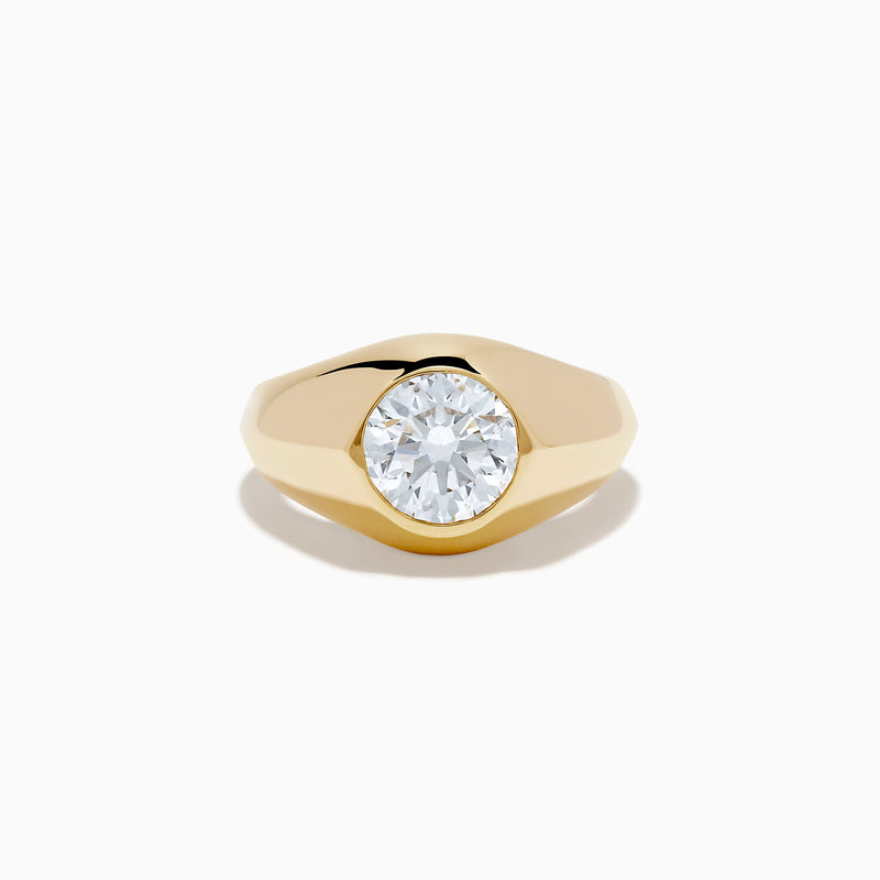 The Lab Grown Diamond Bezel Signet Pinky Ring in 14K Yellow Gold features a wide band and a large, round lab grown diamond at the center, shown against a plain white background.