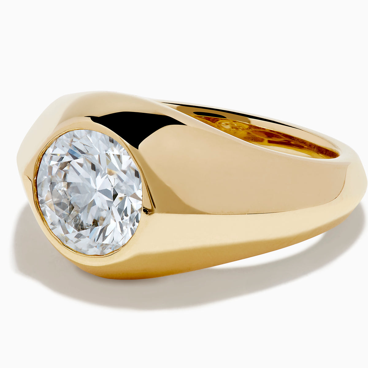 The Lab Grown Diamond Bezel Signet Pinky Ring in 14K Yellow Gold features a wide band and a large, round lab grown diamond at the center, shown against a plain white background.