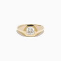 The Lab Grown Diamond Cushion Bezel Signet Pinky Ring in 14K Yellow Gold features a broad band with a cushion-cut lab-grown diamond set in a polished bezel, shown on a plain white background.
