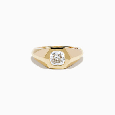 The Lab Grown Diamond Cushion Bezel Signet Pinky Ring in 14K Yellow Gold features a broad band with a cushion-cut lab-grown diamond set in a polished bezel, shown on a plain white background.