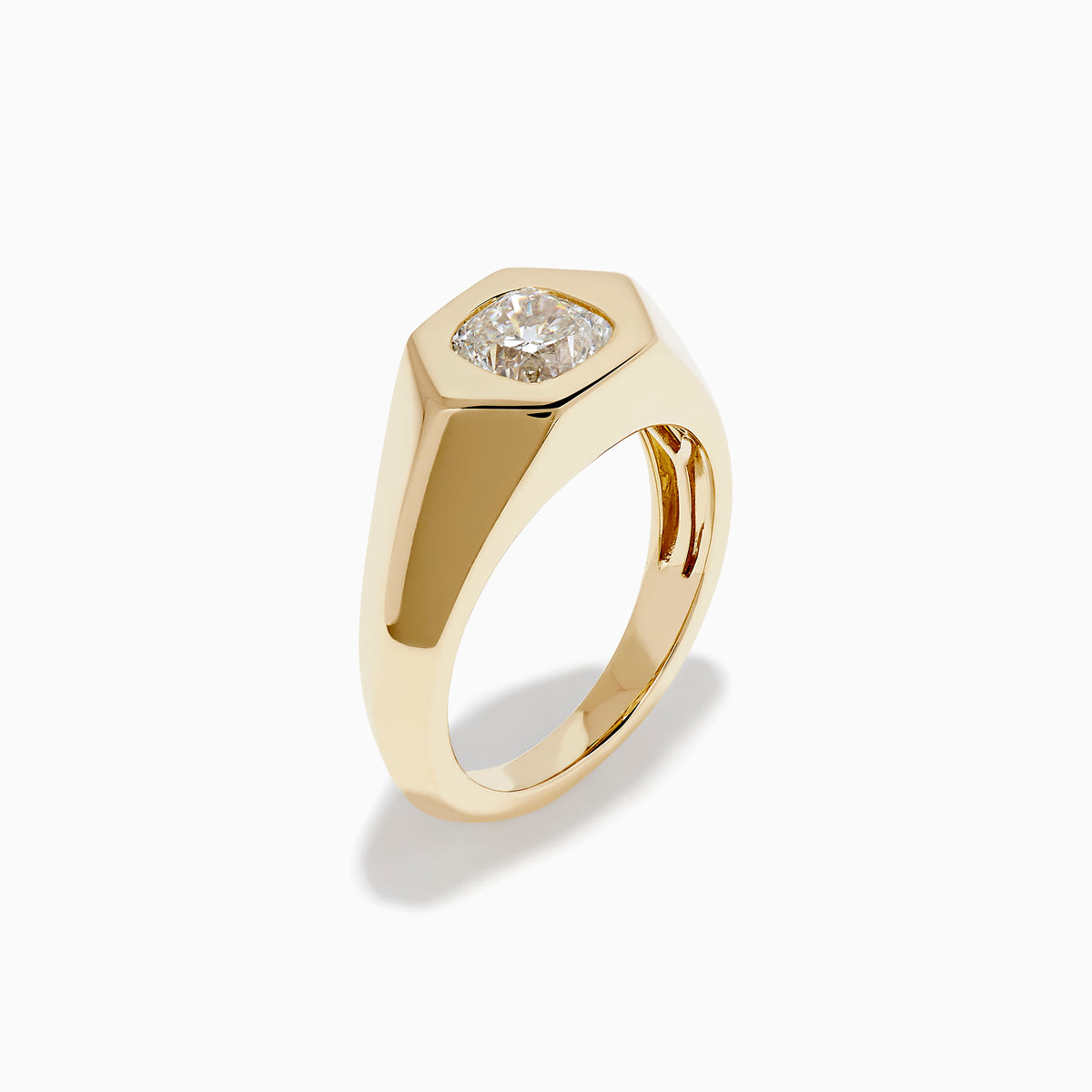 The Lab Grown Diamond Cushion Bezel Signet Pinky Ring in 14K Yellow Gold features a broad band with a cushion-cut lab-grown diamond set in a polished bezel, shown on a plain white background.
