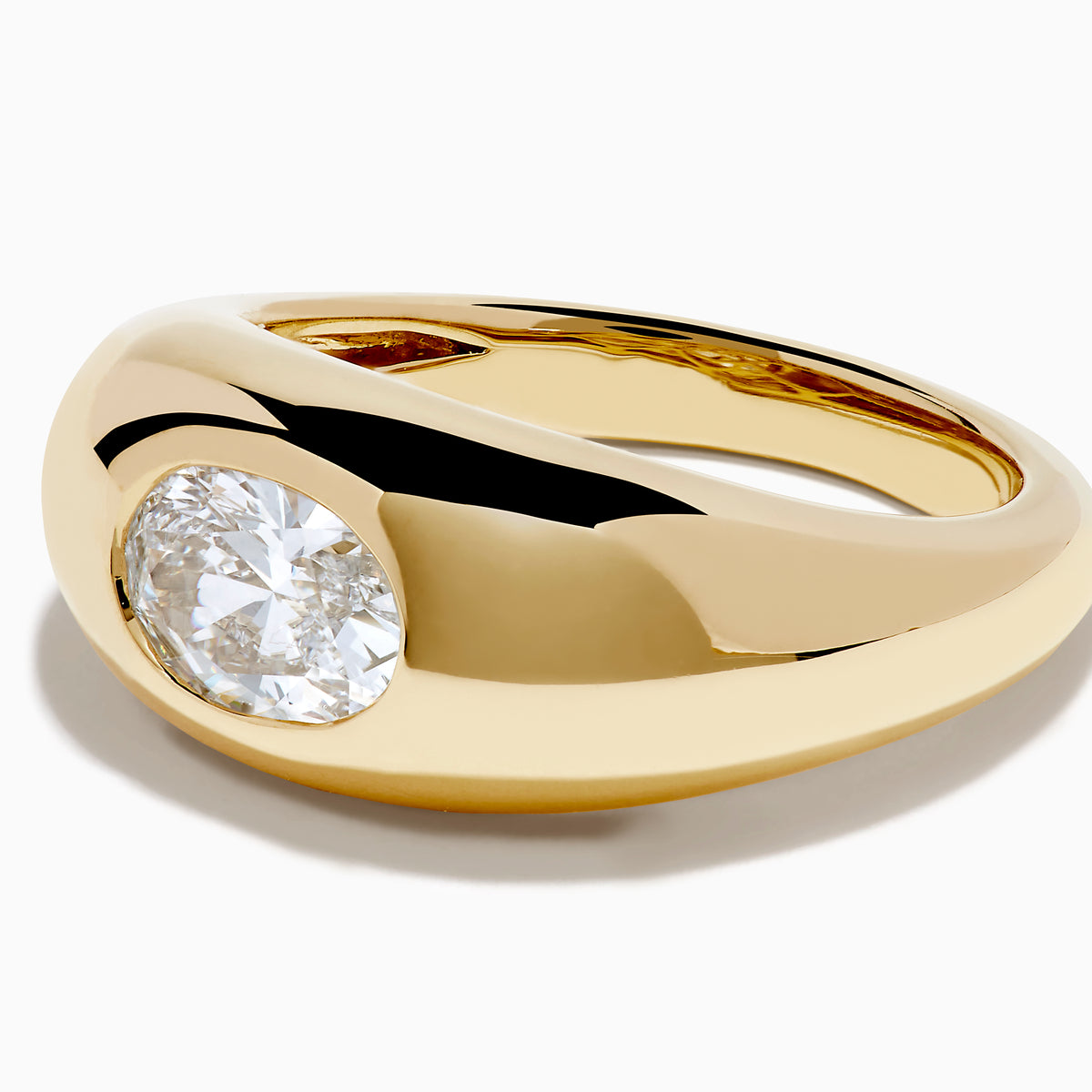 The Lab Grown Diamond Oval Bezel Pinky Ring in 14K Yellow Gold features a wide band and a prominent lab grown oval diamond set in the center.