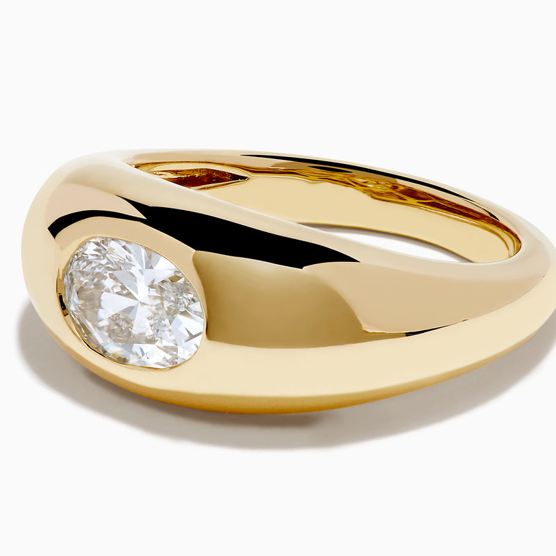 The Lab Grown Diamond Oval Bezel Pinky Ring in 14K Yellow Gold features a wide band and a prominent lab grown oval diamond set in the center.
