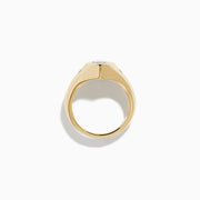 The Lab Grown Diamond Marquise Bezel Pinky Ring in 14K Yellow Gold features a central marquise lab grown diamond, accented by two small round diamonds on each side, all set on a sleek, polished band.