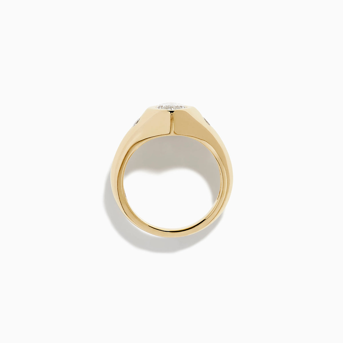 The Lab Grown Diamond Marquise Bezel Pinky Ring in 14K Yellow Gold features a central marquise lab grown diamond, accented by two small round diamonds on each side, all set on a sleek, polished band.