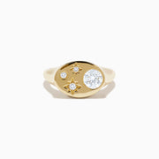 The Lab Grown Diamond Celestial Signet Pinky Ring in 14K Yellow Gold features a flat oval face with three star-shaped lab grown diamonds and one larger round diamond.