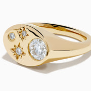 The Lab Grown Diamond Celestial Signet Pinky Ring in 14K Yellow Gold features a flat oval face with three star-shaped lab grown diamonds and one larger round diamond.