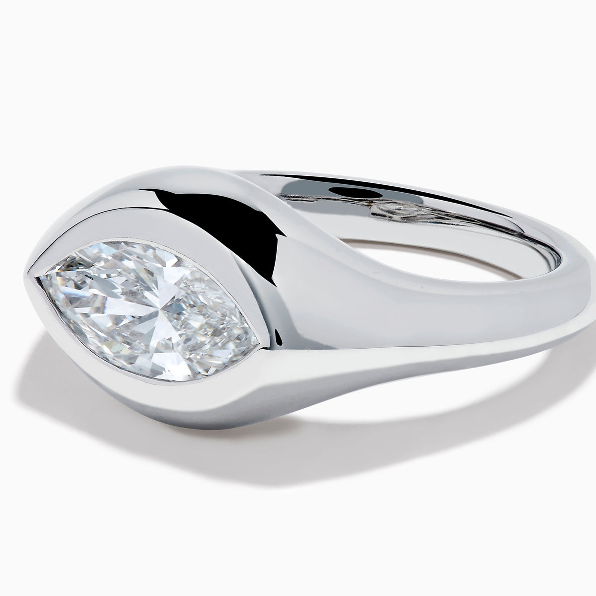 The Lab Grown Diamond Marquise Bezel Pinky Ring in 14K White Gold showcases a large marquise-shaped lab grown diamond set on a smooth, curved band, photographed against a white background.