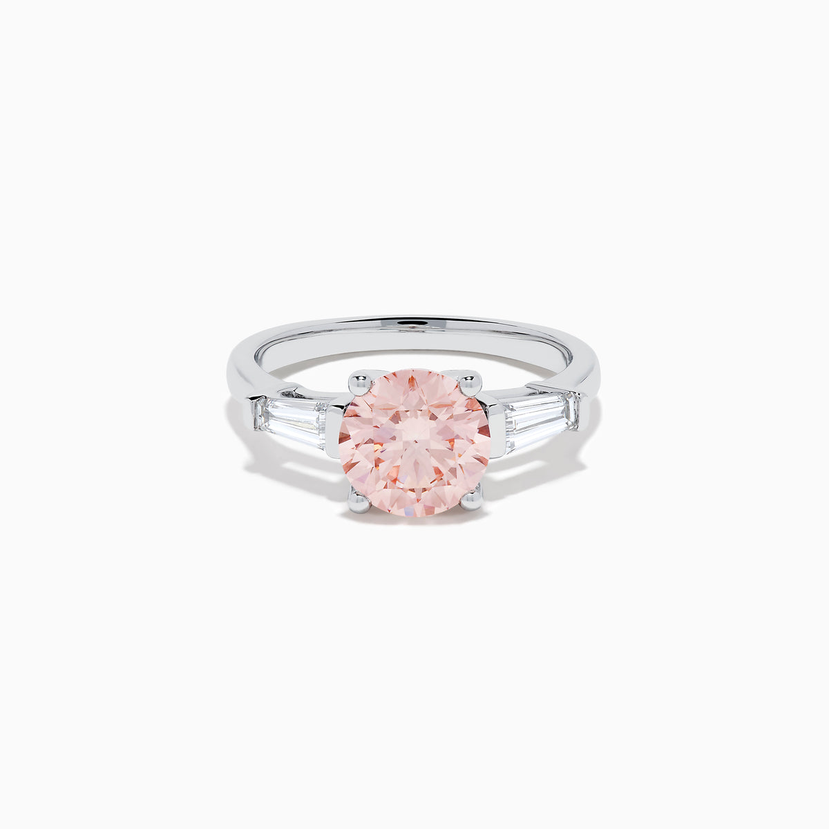 The Lab Grown Pink and White Diamond 3 Stone Ring in 14K White Gold features a striking round pink center stone with two rectangular white diamonds on each side, set against a white background.