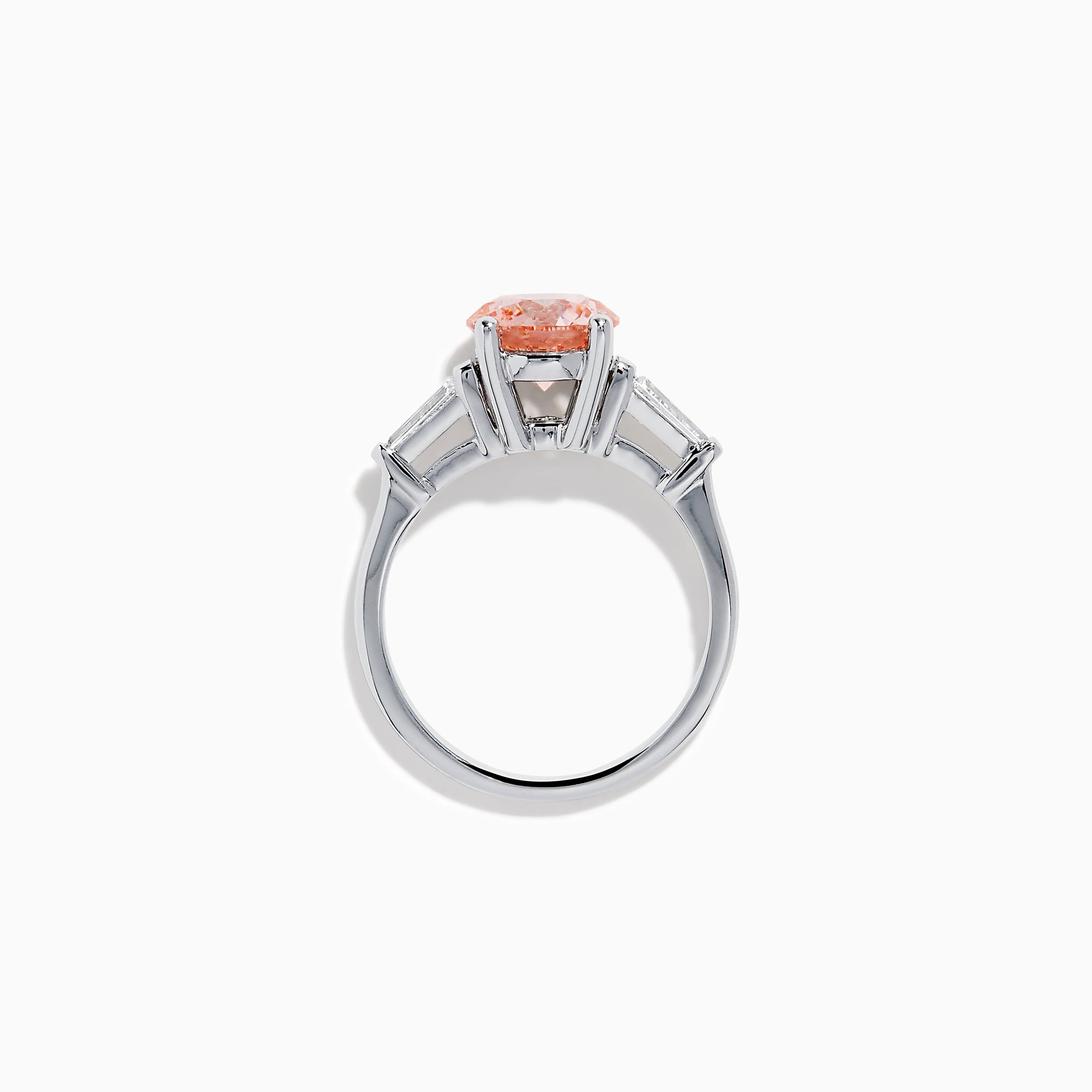 The Lab Grown Pink and White Diamond 3 Stone Ring in 14K White Gold features a striking round pink center stone with two rectangular white diamonds on each side, set against a white background.