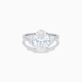 The Lab Grown Oval Diamond 3 Stone Ring in 14K White Gold features a striking lab grown oval diamond center, accented by two pear-shaped diamonds on each side.