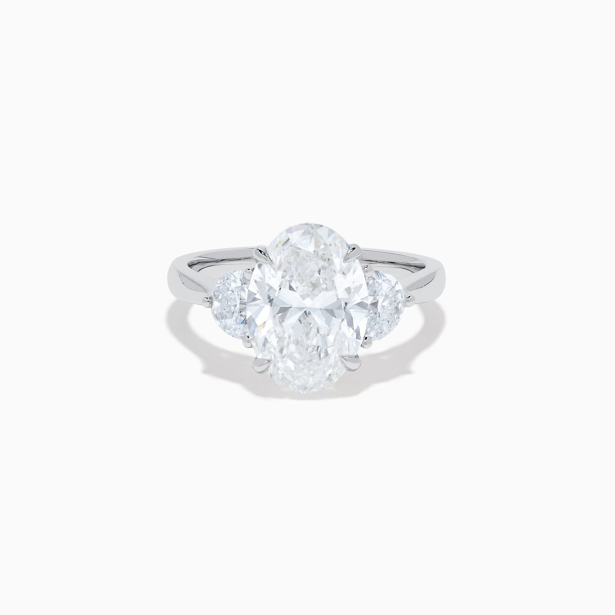 The Lab Grown Oval Diamond 3 Stone Ring in 14K White Gold features a striking lab grown oval diamond center, accented by two pear-shaped diamonds on each side.
