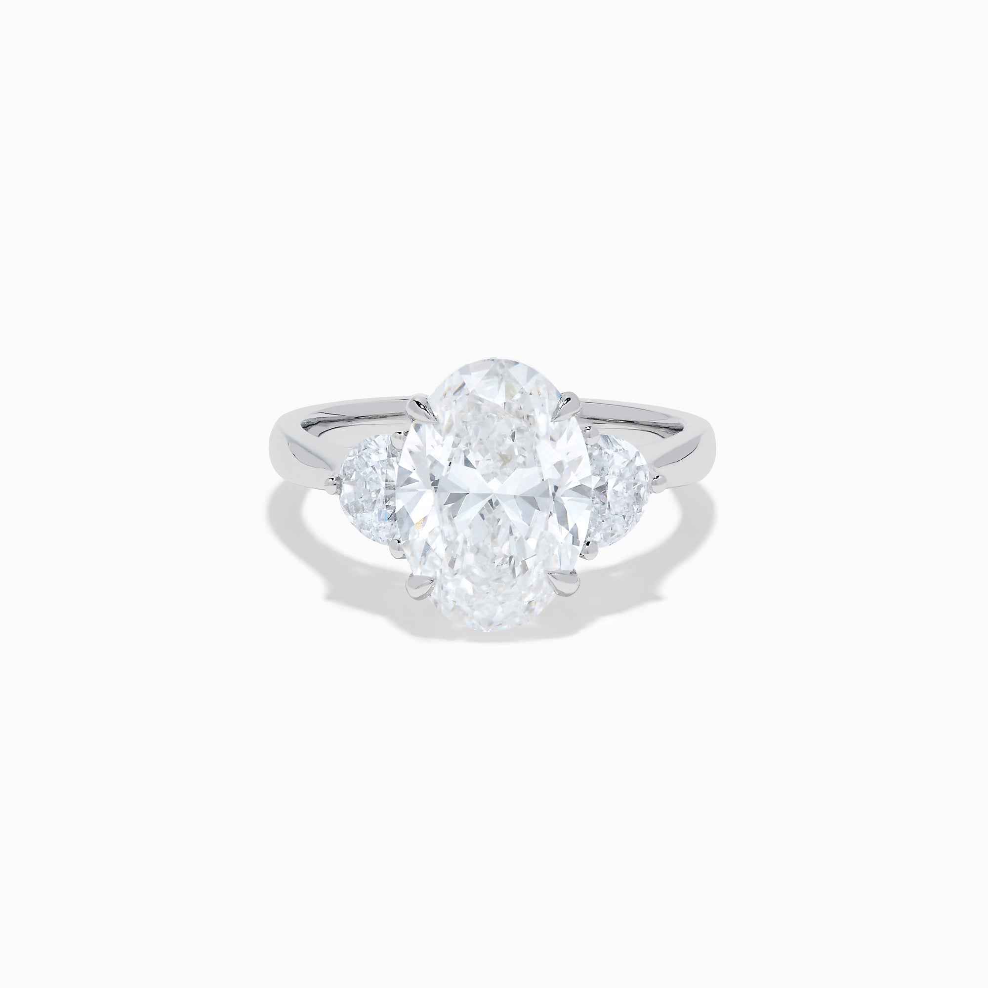 The Lab Grown Oval Diamond 3 Stone Ring in 14K White Gold features a striking lab grown oval diamond center, accented by two pear-shaped diamonds on each side.