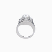 The Lab Grown Oval Diamond 3 Stone Ring in 14K White Gold features a striking lab grown oval diamond center, accented by two pear-shaped diamonds on each side.