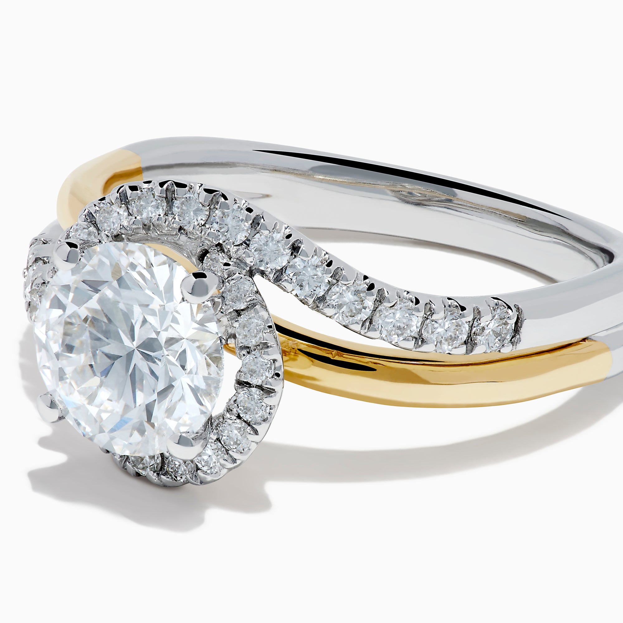 The Lab Grown Diamond Swirl Halo Ring in 14K Two-Tone Gold features a large round lab grown diamond center, surrounded by smaller diamonds in a spiral halo and set on dual gold and silver bands against a crisp white background.