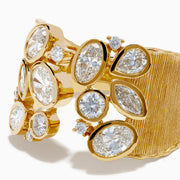 The Lab Grown Multi Shape Diamond Open Shank Textured Ring in 14K Yellow Gold features an open front with oval and marquise lab-grown diamonds arranged in a scattered, leaf-inspired pattern.
