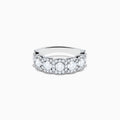 The 14K White Gold Diamond Ring showcases a row of large round diamonds, each encircled by smaller diamonds, forming a sparkling floral design across the band—a stunning example of diamond ring artistry.