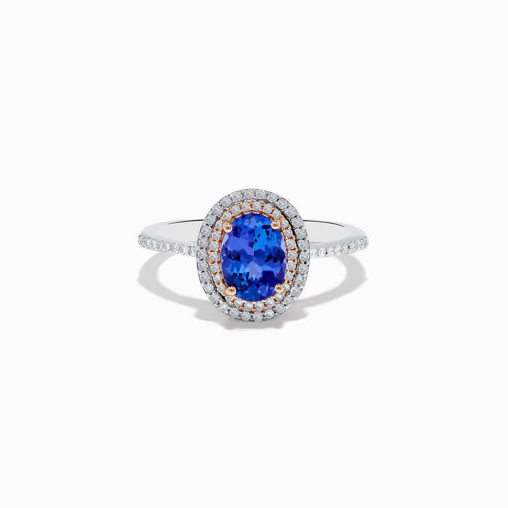 The Nahla Siri 14K Two Tone Tanzanite and Diamond Double Halo Ring features a large oval tanzanite center, double halo of white diamonds, and additional diamonds along the band.