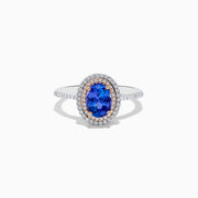 The Nahla Siri 14K Two Tone Tanzanite and Diamond Double Halo Ring features a large oval tanzanite center, double halo of white diamonds, and additional diamonds along the band.