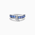The 925 Sterling Silver Tanzanite and Diamond Fin Ring showcases tanzanite stones across the band, accented with a crescent design adorned with sparkling diamonds.