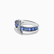 The 925 Sterling Silver Tanzanite and Diamond Fin Ring showcases tanzanite stones across the band, accented with a crescent design adorned with sparkling diamonds.
