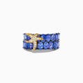 The 925 Silver and 18K Tanzanite and Diamond Starfish Ring features two rows of oval blue tanzanites and a starfish design on the left side, adorned with sparkling white diamonds.