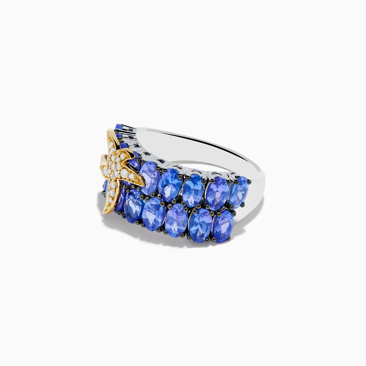 The 925 Silver and 18K Tanzanite and Diamond Starfish Ring features two rows of oval blue tanzanites and a starfish design on the left side, adorned with sparkling white diamonds.