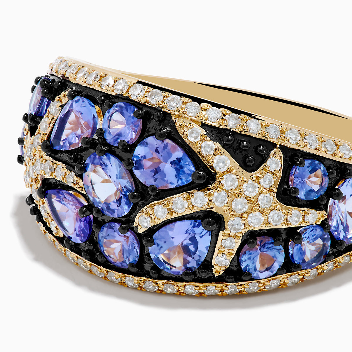 The Nahla 14K Yellow Gold Tanzanite and Diamond Starfish Ring showcases round and pear-shaped blue tanzanites with white and black diamond accents in an intricate, starfish-inspired design.