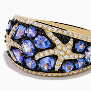 The Nahla 14K Yellow Gold Tanzanite and Diamond Starfish Ring showcases round and pear-shaped blue tanzanites with white and black diamond accents in an intricate, starfish-inspired design.