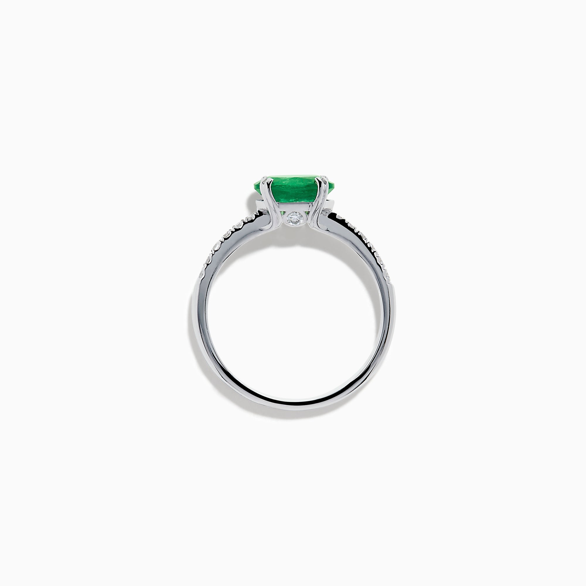 The 14K White Gold East West Oval Emerald and Diamond Ring showcases a striking green oval emerald set horizontally, accented by sparkling diamonds along the band.