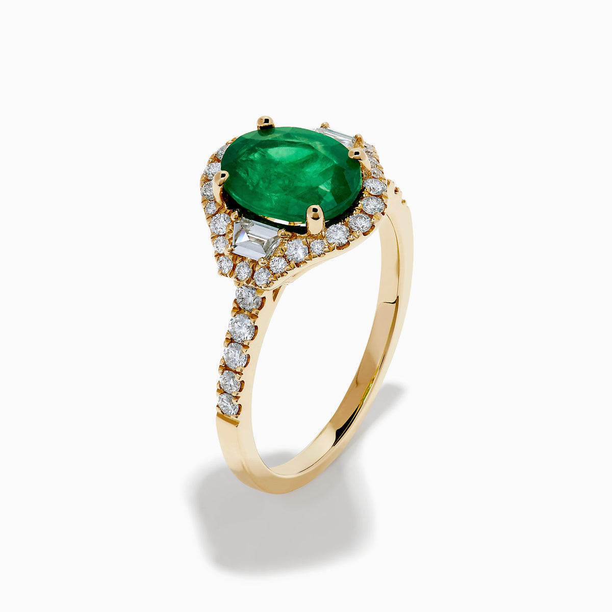The Brasilica 14K Yellow Gold Emerald and Diamond 3 Stone Ring features an oval green emerald and sparkling diamonds on a diamond-studded band—an elegant choice for any occasion.