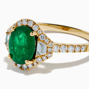 The Brasilica 14K Yellow Gold Emerald and Diamond 3 Stone Ring features an oval green emerald and sparkling diamonds on a diamond-studded band—an elegant choice for any occasion.