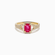 The 14K Yellow Gold Emerald Cut Ruby and Pave Diamond Halo Ring features a central emerald-cut ruby, diamond accents, and a shimmering halo for added brilliance.