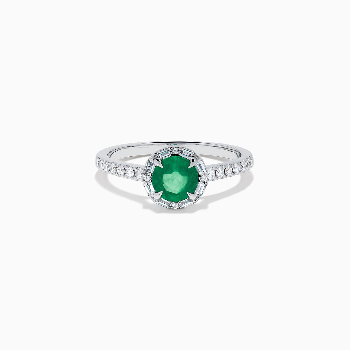 Introducing the 14K White Gold Emerald and Diamond Baguette Halo Ring, showcasing a round green emerald center stone, diamond baguette halo, and a band embellished with shimmering clear stones for added elegance.