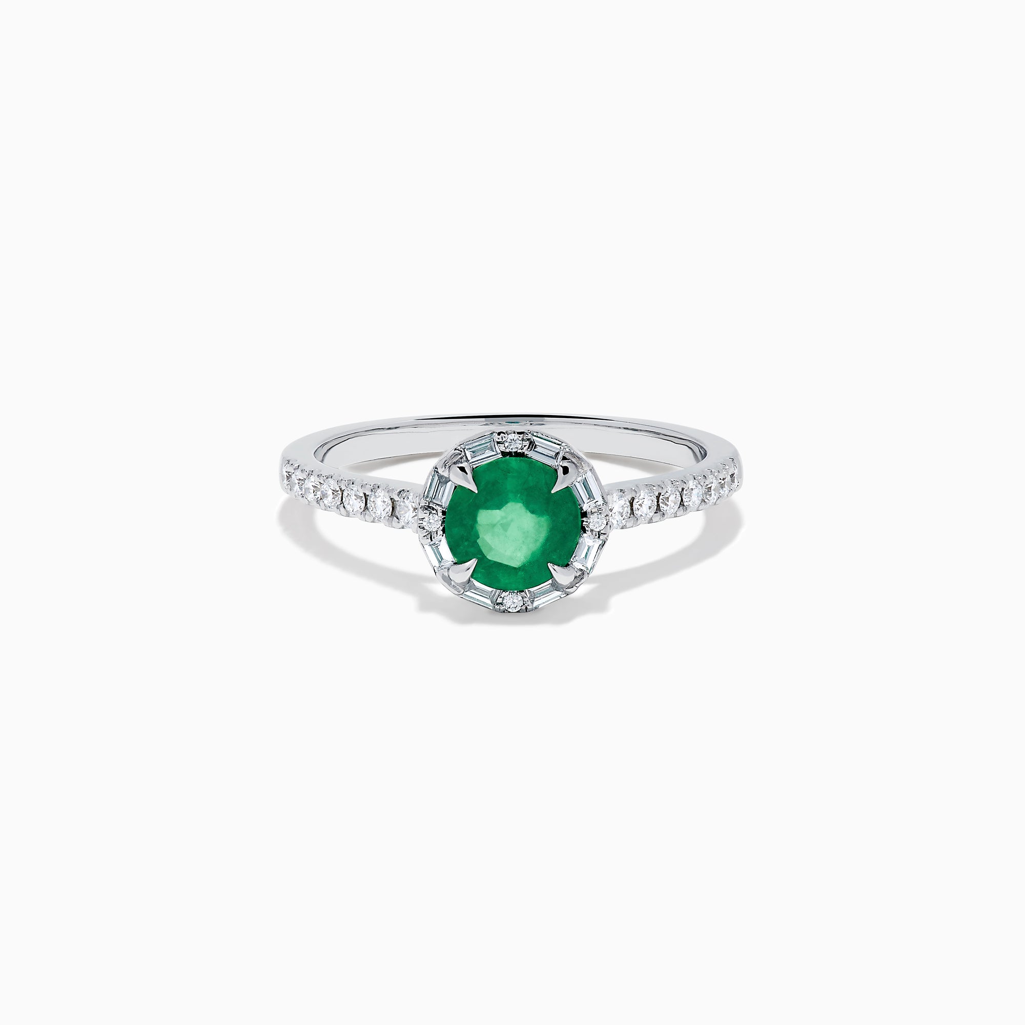 Introducing the 14K White Gold Emerald and Diamond Baguette Halo Ring, showcasing a round green emerald center stone, diamond baguette halo, and a band embellished with shimmering clear stones for added elegance.