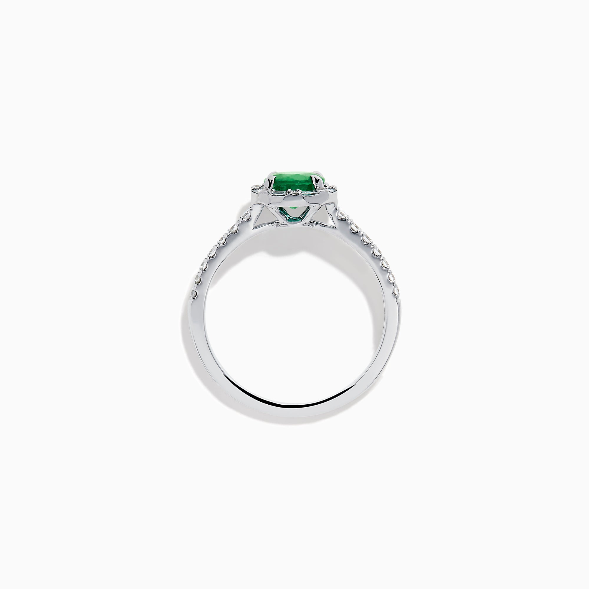 Introducing the 14K White Gold Emerald and Diamond Baguette Halo Ring, showcasing a round green emerald center stone, diamond baguette halo, and a band embellished with shimmering clear stones for added elegance.
