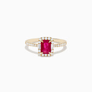 The Ruby Royale 14K Yellow Gold Ruby and Diamond Halo Ring features a rectangular ruby center, surrounded by a halo of round and baguette diamonds, with extra diamond accents on the band for added brilliance.