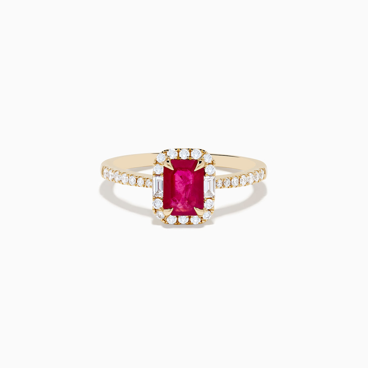The Ruby Royale 14K Yellow Gold Ruby and Diamond Halo Ring features a rectangular ruby center, surrounded by a halo of round and baguette diamonds, with extra diamond accents on the band for added brilliance.