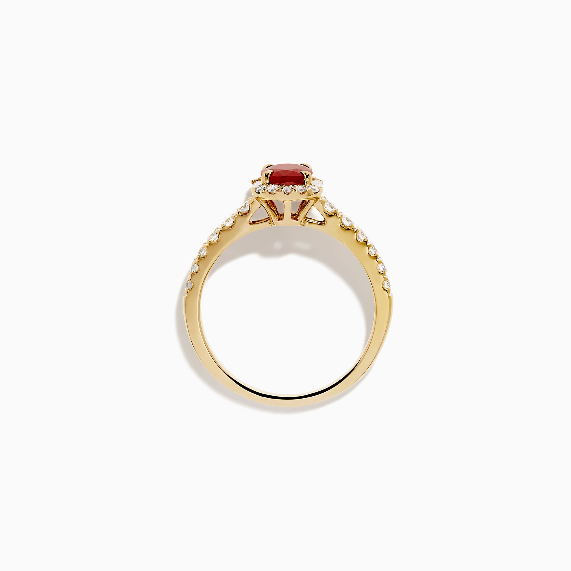The 14K Yellow Gold Oval Ruby and Diamond Halo Ring features a central oval ruby surrounded by a sparkling diamond halo, with additional diamonds adorning the elegant band.