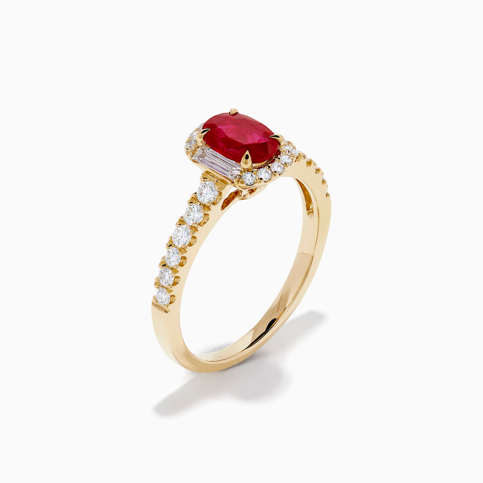 The 14K Yellow Gold Oval Ruby and Diamond Halo Ring features a central oval ruby surrounded by a sparkling diamond halo, with additional diamonds adorning the elegant band.