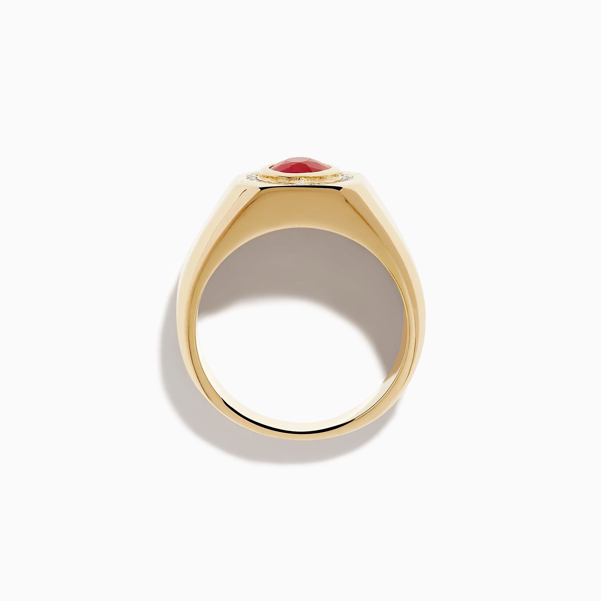 The Men's 14K Yellow Gold Bezel Halo Ruby and Diamond Signet Ring showcases an oval ruby center, encircled by a halo of white diamonds, all set in yellow gold against a white background.