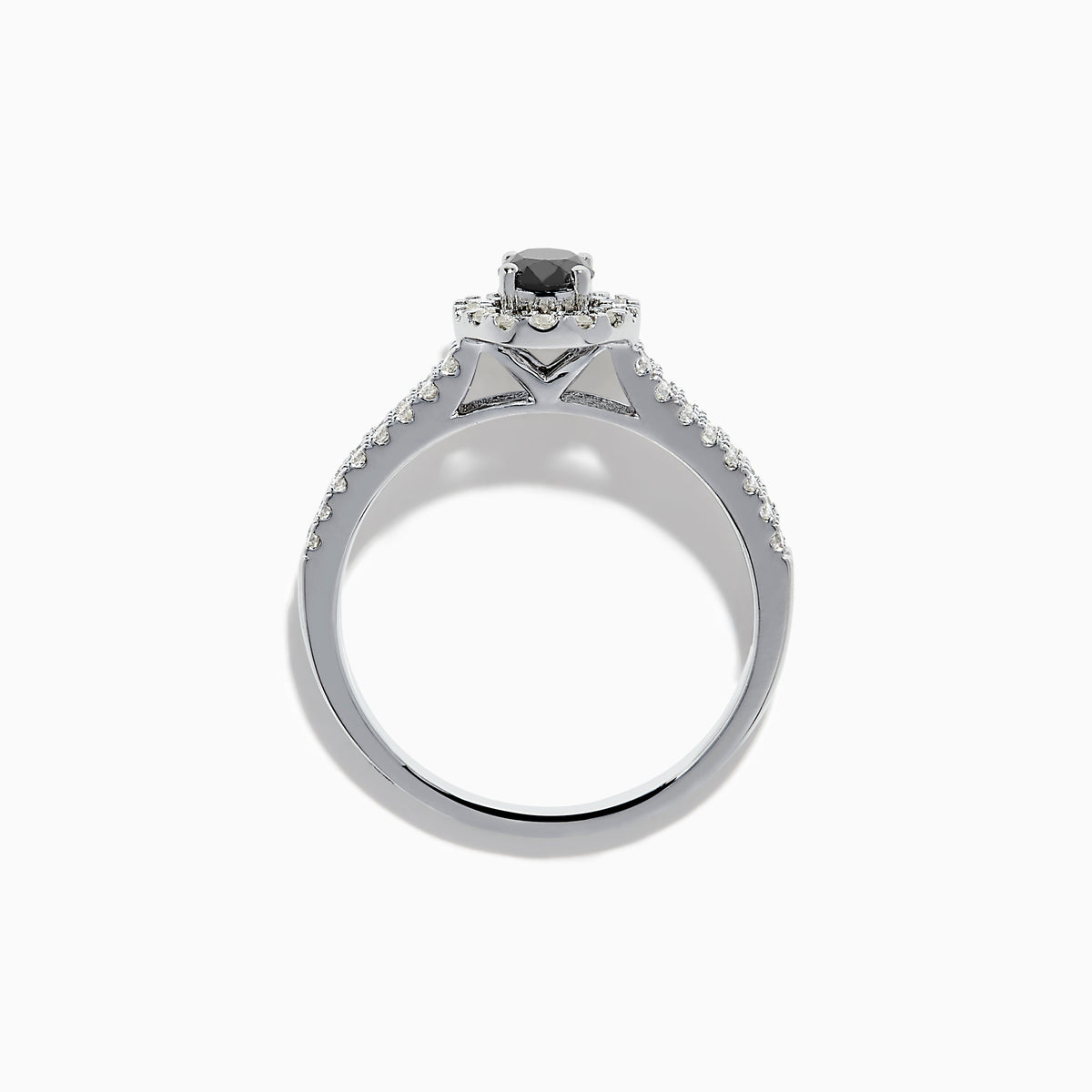 The 14K White Gold White and Black Diamond Halo Ring features an oval black center stone, a halo of white diamonds, and additional diamonds set along its split shank band.