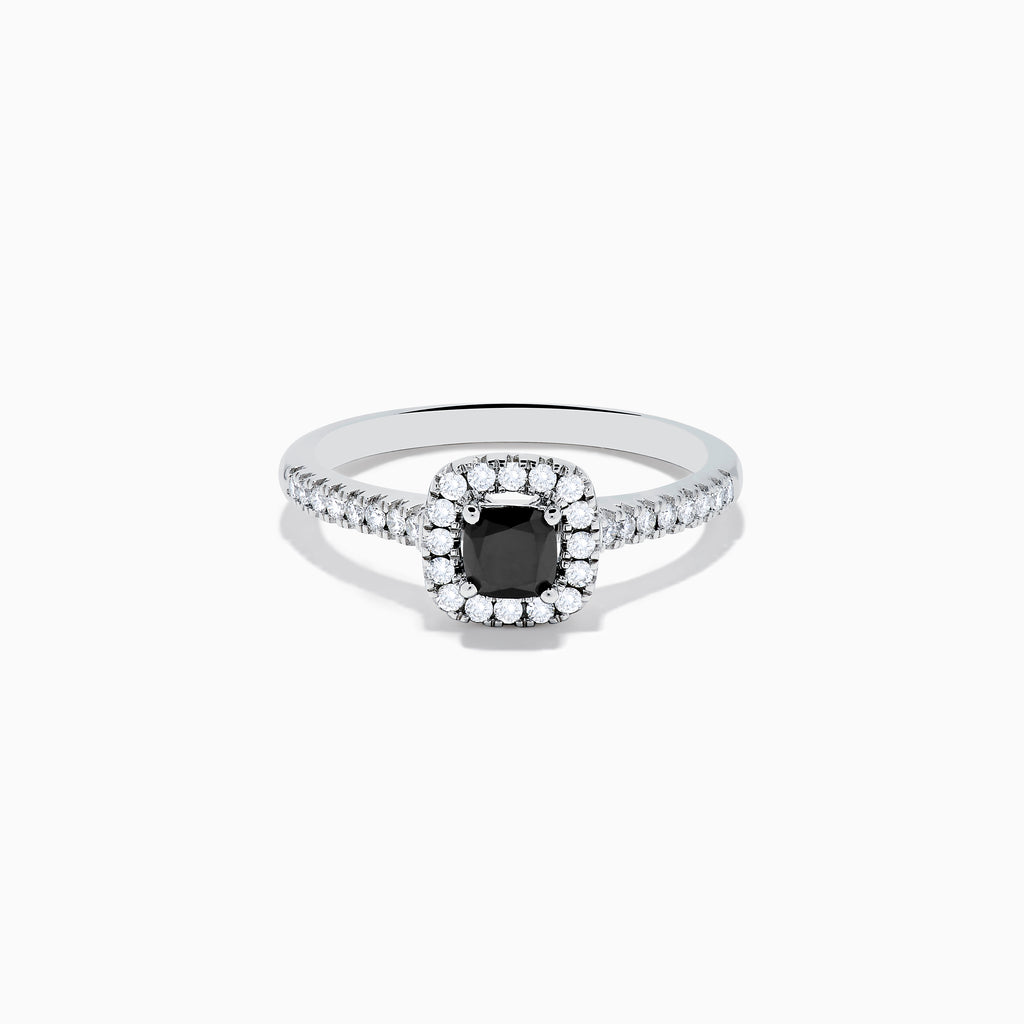 The 14K White Gold White and Black Diamond Halo Ring features a rectangular black center stone surrounded by white diamonds, with more diamonds along the band, all presented on a white background.